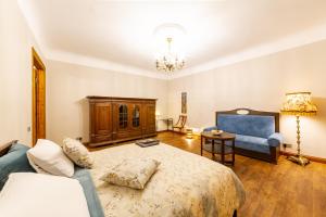 a bedroom with a bed and a couch and a chair at Cozy Storie's AP, 47sqm, Renovated 2020, Free parking in Riga