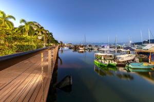 boats are docked at a pier near the water at Piermonde Apartments Cairns in Cairns