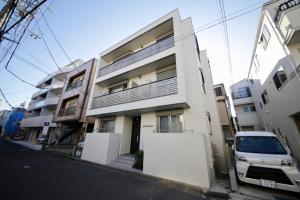 a white van parked in front of a building at Frieden Haus in Tokyo