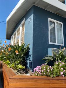 a blue house with flowers in front of it at Seaway Inn in Santa Cruz