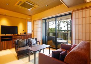 a living room with a couch and chairs and a television at Awaji Hamarikyu Takumi in Minamiawaji