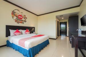 Un pat sau paturi într-o cameră la OYO 1633 Hotel Darma Nusantara 3