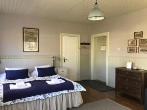 a bedroom with a bed with two towels on it at Mellby 11 Bed & Breakfast in Kivik