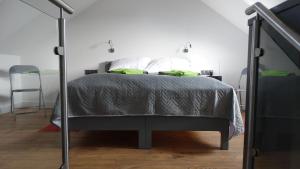 a bedroom with a bed with green pillows on it at DOMINO-APARTAMENTY Green in Krościenko +45 photos