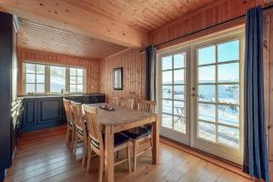 a dining room with a wooden table and chairs at Haukelifjell Skisenter in Vågsli
