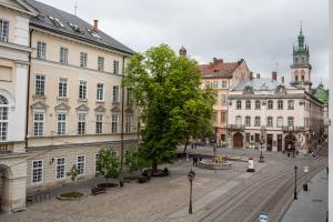 une rue dans une ville avec des bâtiments et un arbre dans l'établissement OnLviv Apartments Rynok Square 18, à Lviv