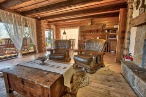 a living room with chairs and a table in a cabin at Saarelux Riverise Villa in Mõraste