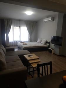 a living room with a couch and a bed and a table at LUXURY SUITES 3 in Karlovo