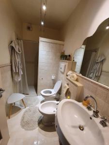 a bathroom with a white toilet and a sink at Pietra E Glicine B&B in Pieve a Nievole
