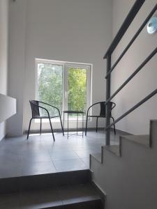 a living room with two chairs and a table at LUXURY SUITES in Karlovo