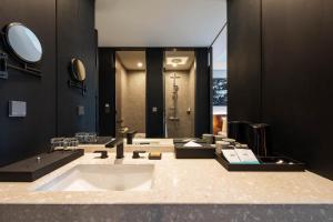 a bathroom with a large tub and a large mirror at Mercure Ambassador Seoul Hongdae in Seoul +65 photos