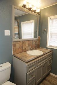 a bathroom with a sink and a mirror at 1 bedroom with a fireplace close to base in Lawton