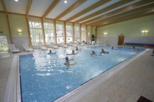 a group of people in a swimming pool at Millennium Health Resort & Spa in Międzywodzie