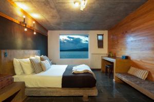 Ένα ή περισσότερα κρεβάτια σε δωμάτιο στο Hotel Altiplanico Puerto Natales