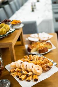 a table topped with plates of pastries and other foods at Parador de El Hierro in Las Casas