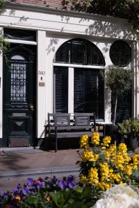 a bench in front of a building with flowers in front of it at Villa360 in Amsterdam