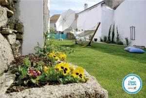 a flower bed in the yard of a house at Casa dos Edras in Miranda do Douro