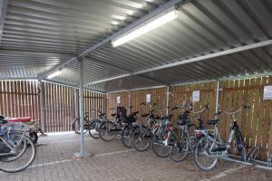 a row of bikes parked in a garage at Fletcher Hotel Restaurant De Gelderse Poort in Ooij