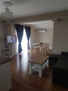 a living room with a table and a dining room at LUXURY SUITE 2 in Karlovo