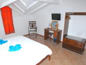 a bedroom with a bed and a desk and a chair at Hotel MiraBela in Santa Maria