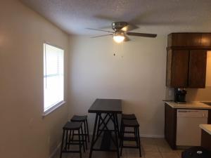 a kitchen with a table and stools in a room at Fully furnished two bedroom apartment in Lawton