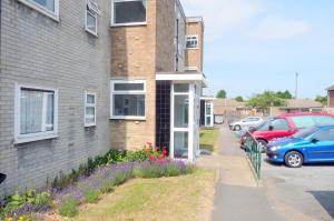 a house with cars parked in front of it at Wentworth Apartment with 2 bedrooms, Superfast Wi-Fi and Parking in Sittingbourne