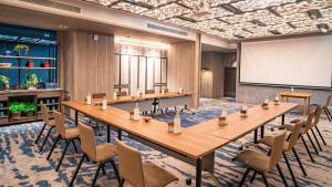a conference room with a large wooden table and chairs at Hotel Indigo Phuket Patong by IHG in Patong Beach +213 photos