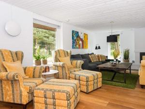 a living room with couches and a couch at 6 person holiday home in Ulfborg in Fjand Gårde