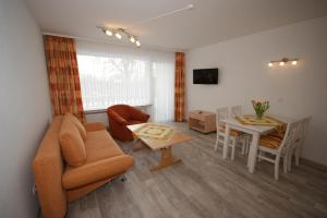 a living room with a couch and a table at Hotel und Cafe Panorama in Braunlage