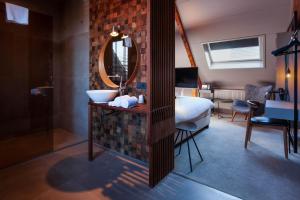a living room with a large bed and a large mirror at Boutiquehotel Staats in Haarlem