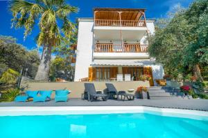 a house with a swimming pool in front of a house at Villa Anna in Kallirakhi