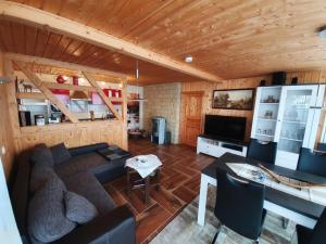 a living room with a couch and a table at Ferienhäuser in Allrode in Thale