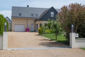 a house with a driveway and a garage at Mon Saint Michel in Ardevon