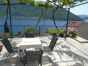 a table and chairs with a view of a lake at Apartments Jovanović in Perast