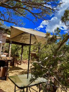 un paraguas sentado en una mesa en un patio en The Chi-Treehouse at Sunny Mellow Eco Villa en Tijeras