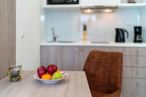 a bowl of fruit on a table in a kitchen at White & Gray apartment in Rethymno