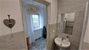a bathroom with a sink and a mirror at Pokoje Gościnne Puławska 41 in Kazimierz Dolny +42 photos