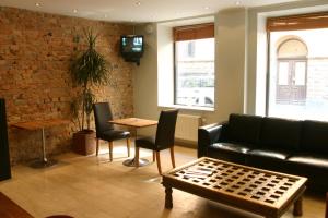 a living room with a couch and a table at Rex Hotel in Stockholm