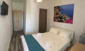 a bedroom with a bed with two towels on it at EUROPEAN HOUSE in Constanţa