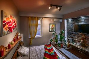 a living room with a couch and a tv at Aerport - Natura Apartment in Belgrade
