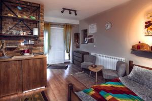 a living room with a bed and a kitchen at Aerport - Natura Apartment in Belgrade