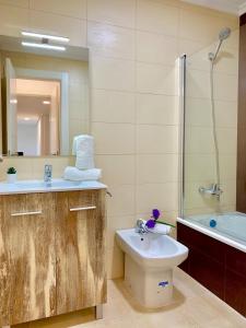 a bathroom with a sink and a toilet and a shower at Apartamento El Socaire Playa Trengandín in Noja