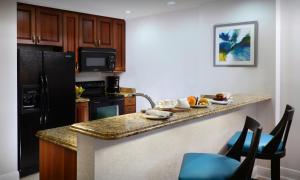 a kitchen with a black refrigerator and a counter top at Naples Bay Resort and Marina in Naples