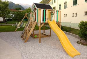 a playground with a slide and a play house at Apartment and room Anica in Tolmin