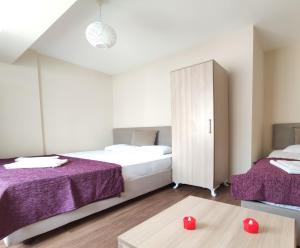 a bedroom with two beds and a cabinet at Karina Butik Apart in Didim