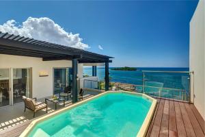a swimming pool on a deck with a view of the ocean at Royalton Negril, An Autograph Collection All-Inclusive Resort in Negril