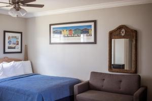 A bed or beds in a room at Riptide Oceanfront Hotel
