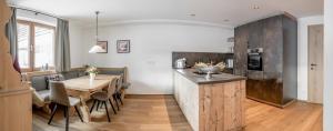 a kitchen and dining room with a wooden table at Bühlhof Appartements in Lech am Arlberg