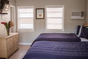 A bed or beds in a room at Riptide Oceanfront Hotel