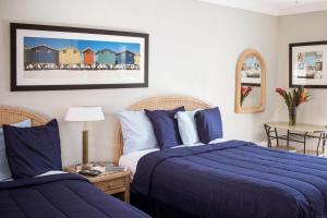 A bed or beds in a room at Riptide Oceanfront Hotel